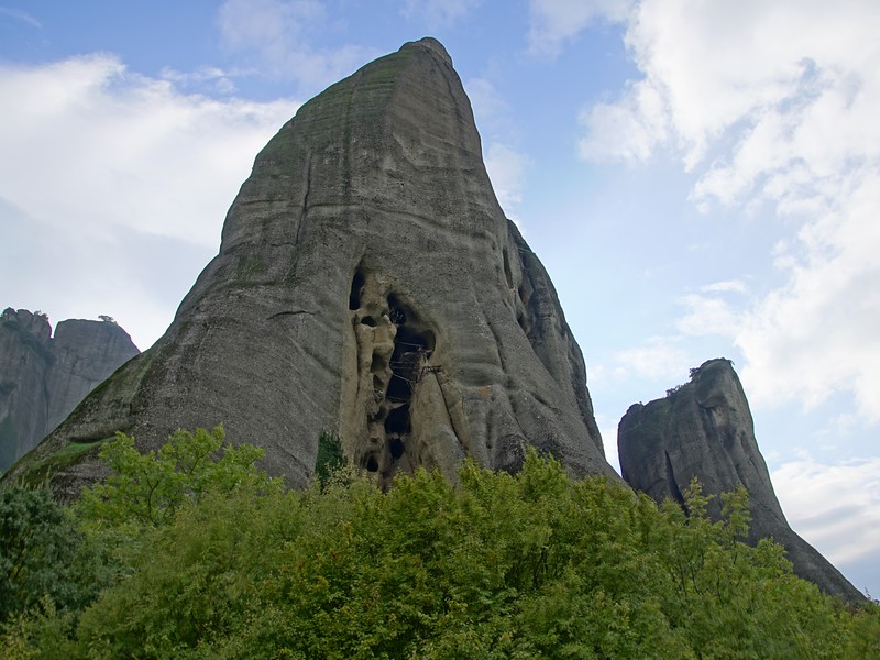 Meteora's cave jail for monks in Greece with imposing views from a hiker's vantage point 