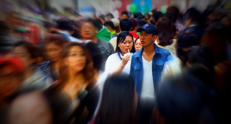 Motion blur select focus of crowds and a couple in Namdaemun market in Seoul, Korea 