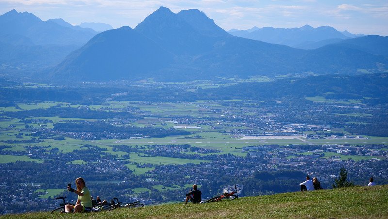Mountain views from atop Gaisberg with hikers and bikers and others taking it all in visiting Austria 