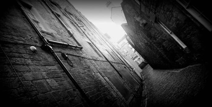 Narrow alley close in Edinburgh, Scotland in greyscale 