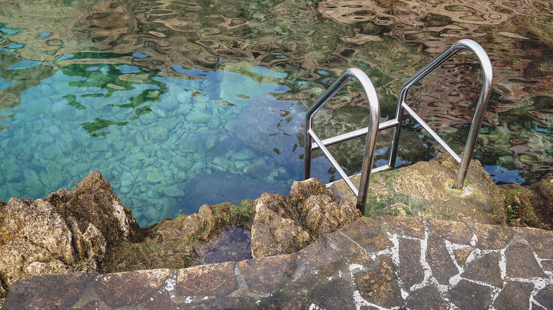 Natural pools along the coast in Rovinj where you can use a pool ladder to climb down in for a dip in Croatia 
