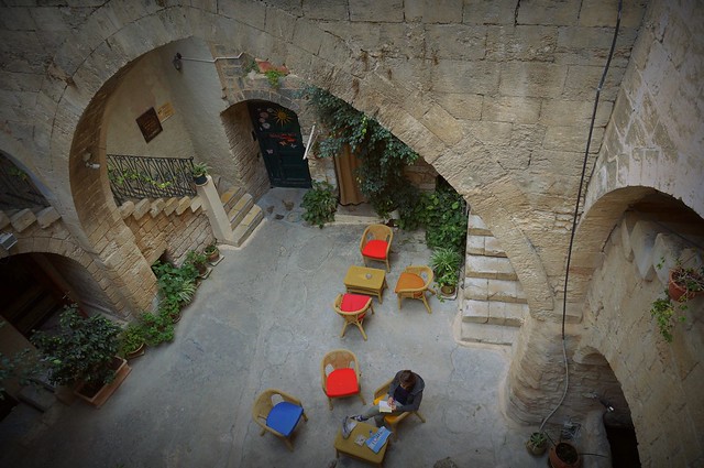 Nazareth Fauzi Azar Inn views of the courtyard in Israel from an overhead perspective with chairs and tables and staircases 