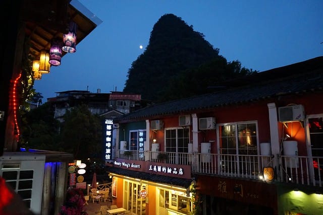 Night time view of Yangshuo, China with colorful lights on the buildings and lanterns