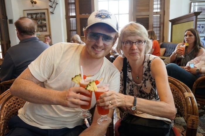 Nomadic Samuel and his Mom enjoying a Singapore Sling at the Raffles Hotel 