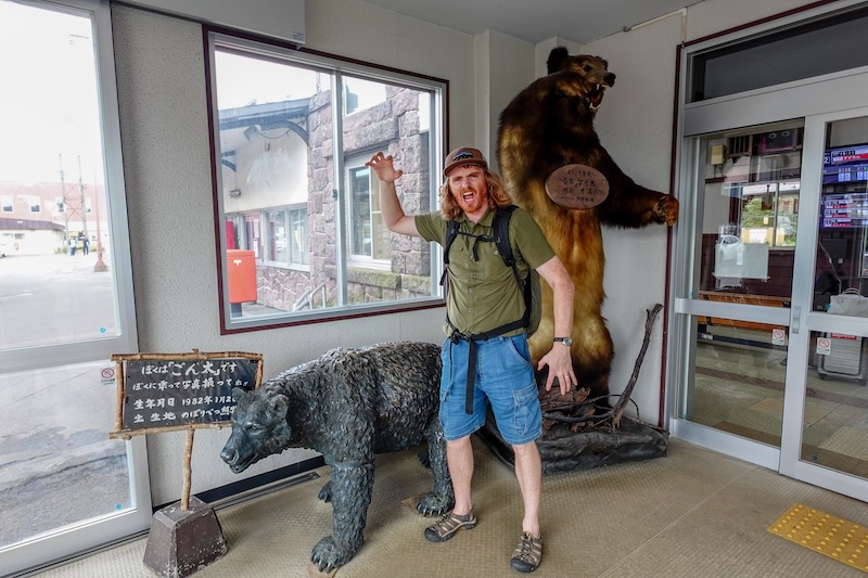 Nomadic Samuel and scary bears at the train station near Noboribetsu, Japan 