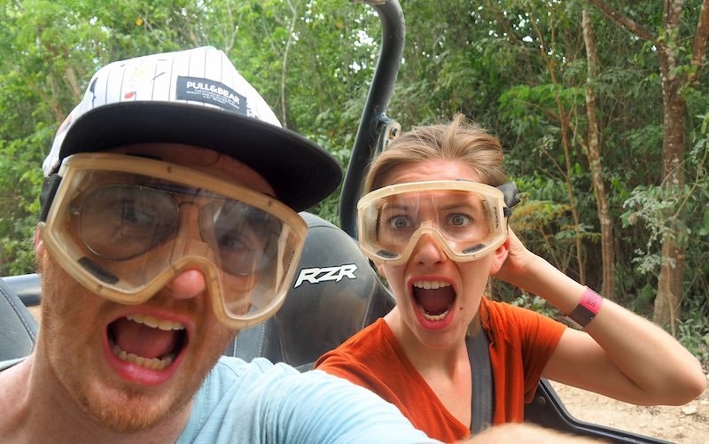 Nomadic Samuel and That Backpacker Audrey Bergner making silly faces while riding an ATV through the jungle near Playa del Carmen, Mexico, wearing protective goggles during an adventurous off-road excursion Nomadic Samuel and That Backpacker Audrey Bergner making silly faces while riding an ATV through the jungle near Playa del Carmen, Mexico, wearing protective goggles during an adventurous off-road excursion