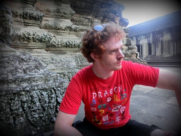 Nomadic Samuel contemplating his temples of Angkor experience in Cambodia 
