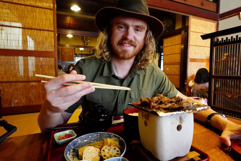 Nomadic Samuel eating hida beef with chopsticks in Takayama, Japan Nomadic Samuel eating hida beef with chopsticks in Takayama, Japan