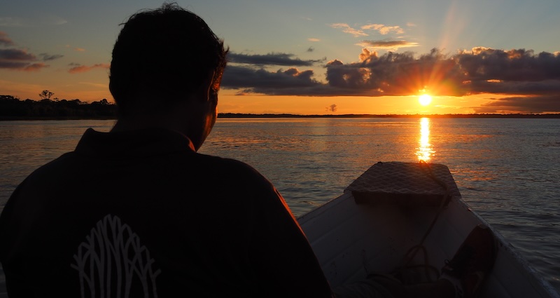 Nomadic Samuel enjoying an epic sunset in the Peruvian amazon jungle 