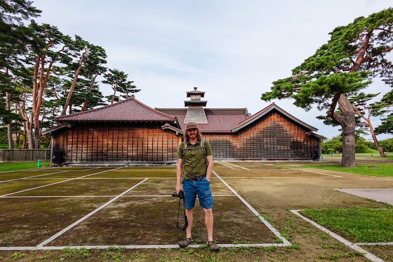 Nomadic Samuel exploring Hakodate on foot in Japan with camera in hand 