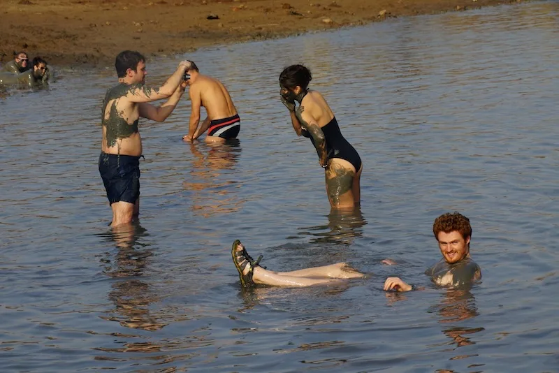 Nomadic Samuel floating in the Dead Sea with other tourists in Israel 