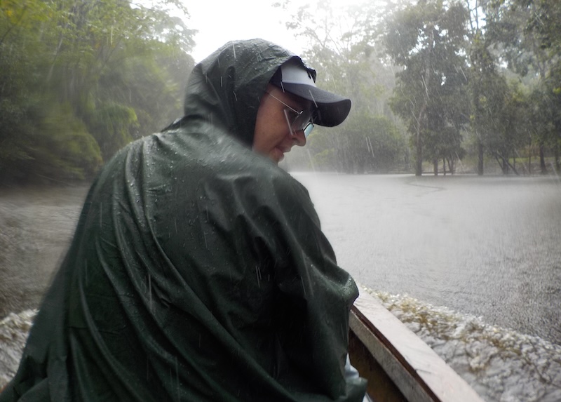 Nomadic Samuel getting absolutely soaked during a torrential downpour experiencing extreme weather in the the Amazon of Peru 