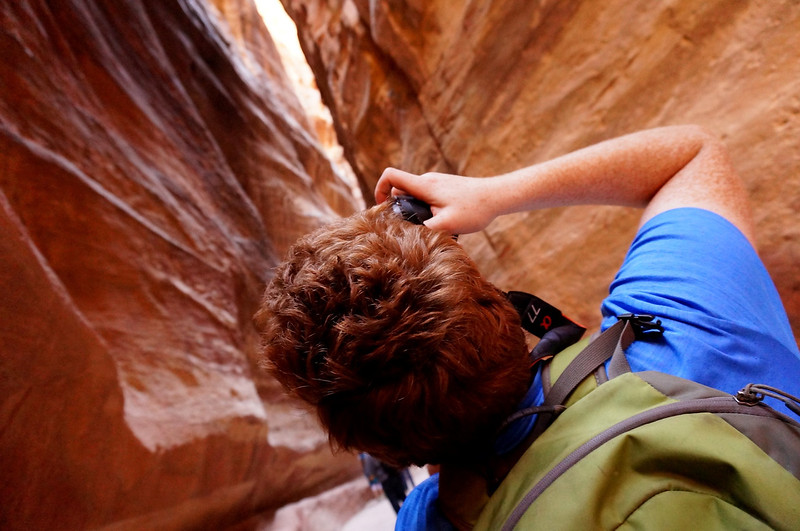 Nomadic Samuel hunkering down to take photos from distinct, creative and unique vantage points at The Siq, Petra, Jordan 