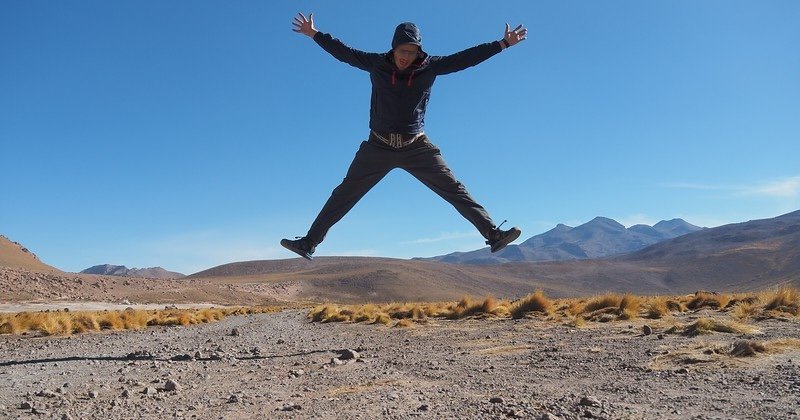 Nomadic Samuel Jeffery jump shot in the Atacama Desert near El Tatio Geysers, Chile, celebrating adventure travel in the Andes mountains