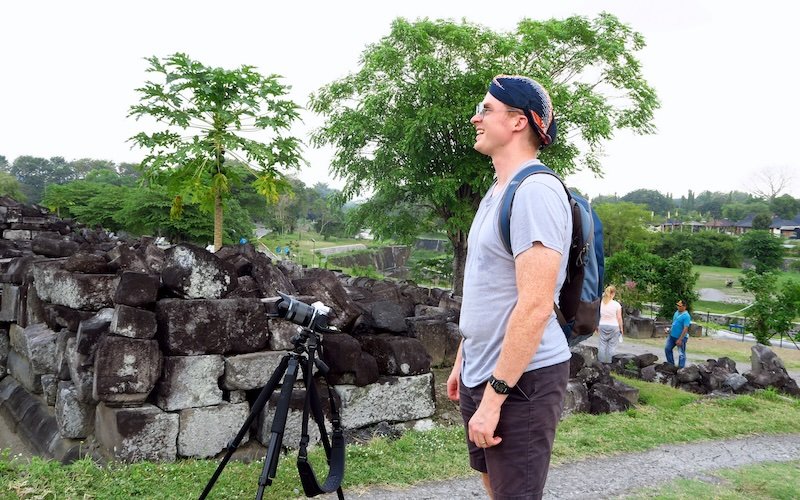 Nomadic Samuel setting up camera on tripod photography in Indonesia 