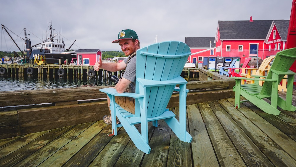 Nomadic Samuel thrilled to be visiting Lunenburg sitting down just taking it all in visiting Nova Scotia, Canada 