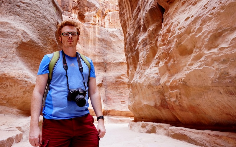 Nomadic Samuel with a camera, t-shirt, shorts and day pack visiting Petra, Jordan aka The Lost City 