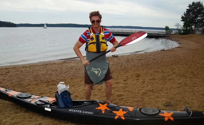 Nomadic Samuel with paddle in hand ready for his kayaking trip in the Archipelago Sea in Finland 