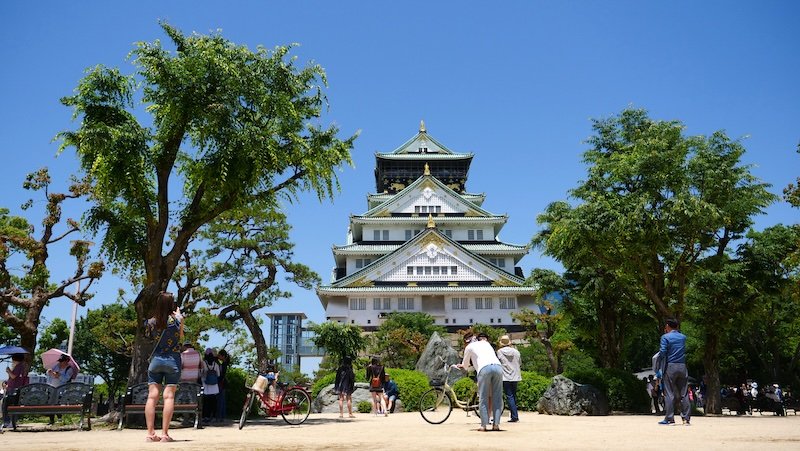 Osaka Castle on a gorgeous day in Japan with That Backpacker Audrey Bergner taking photos and admiring its grandeur 
