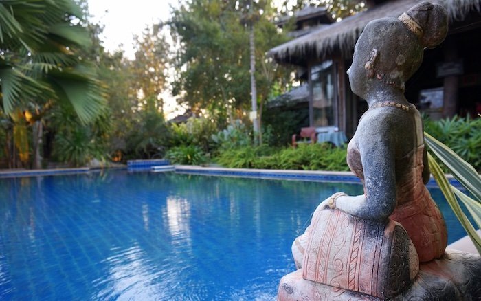 Our charming and laidback swimming pool in Pai, Thailand with Thai cultural decorations all around it 