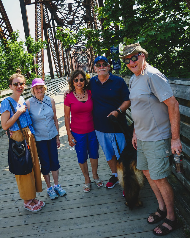 Our family on Fredericton's Pedestrian Railway Bridge celebrating the crossing with Togo the dog in Tow and That Backpacker Audrey Bergner