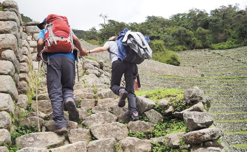Our Peruvian guide lending a helping hand hiking the Inca Trail in Peru 