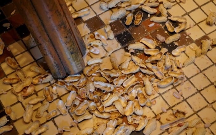 Peanut shells tossed on the floor of the Raffles Hotel in Singapore whilst drinking a Singapore Sling 