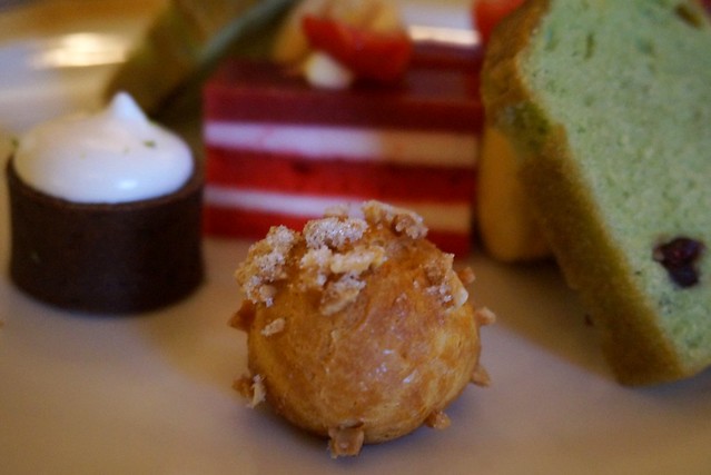 Plate with cakes, macaroons, and sweet treats for afternoon tea at The Peninsula Hotel in Hong Kong make for delectable bites