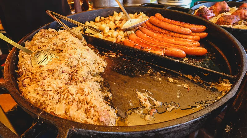 Polish food featuring hunters stew and Kielbasa sausage macro details at Malbork Castle in Poland