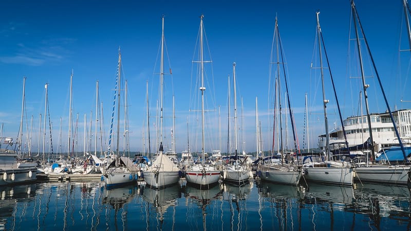 Pula Marina with rows of sailboats on a quiet day out on the water