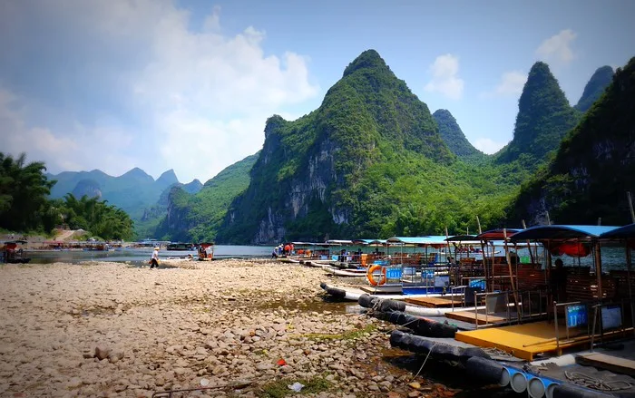Rafting down the Li River in Yanghsuo, China with Karst Mountain Views: The bamboo rafts on the shores of the Li River.