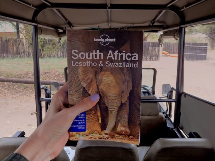 Reading our South Africa Lonely Planet guidebook whilst on safari in South Africa 