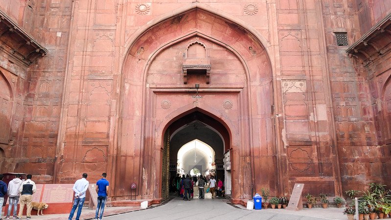 Grand arched gateway of the Red Fort in Delhi, India, a UNESCO World Heritage Site showcasing iconic Mughal architecture with intricate carvings and red sandstone walls