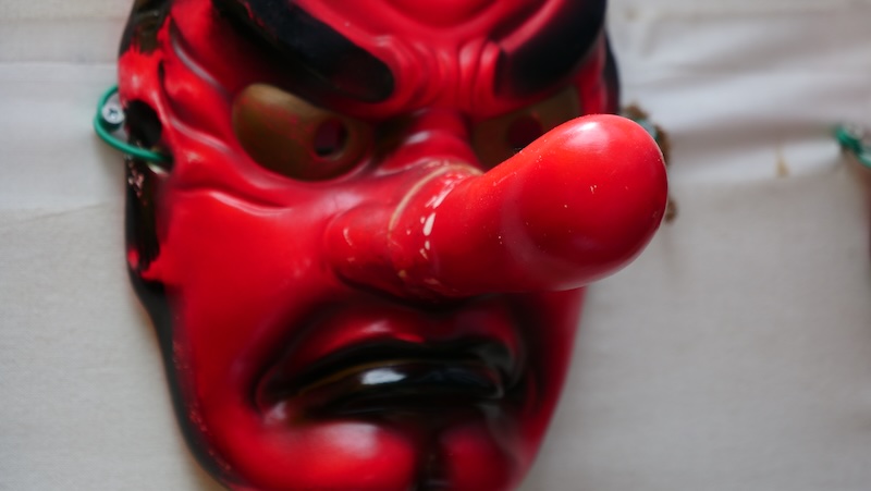 Red mask with a long pointy nose on Mount Takao, Japan 