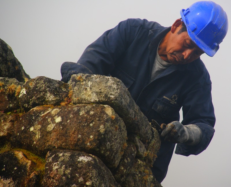 Restoration and repair work being done at Machu Picchu in the rain 