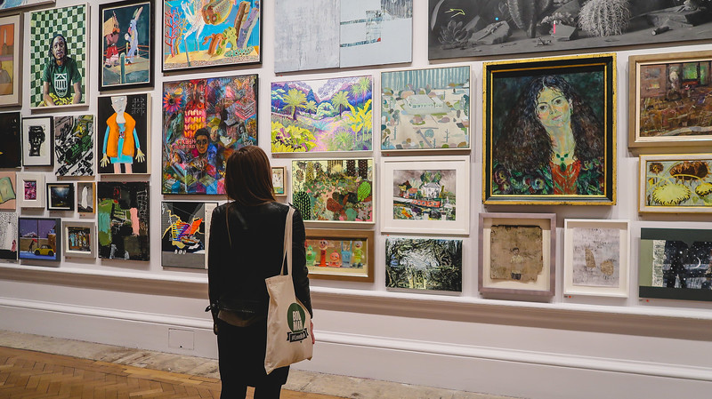 Royal Academy of Arts with many pieces of art on display on the wall as viewed by That Backpacker Audrey Bergner 