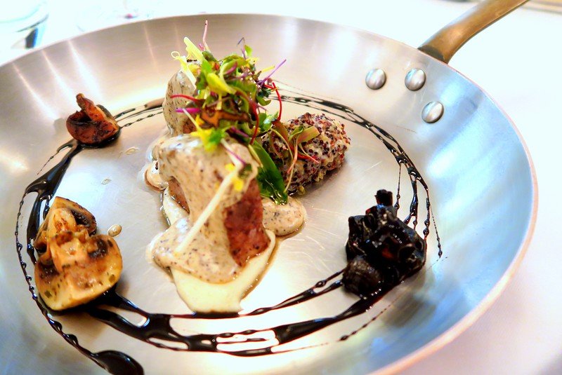Gourmet fine dining dish of seared beef medallions with creamy truffle sauce, mushrooms, microgreens, and artistic balsamic reduction plating at Royal Hideaway Playacar in Playa del Carmen, Mexico