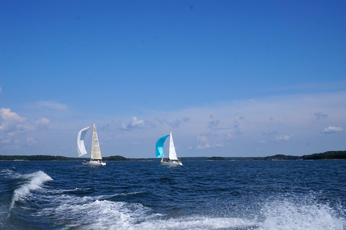 Sailboats out on the Baltic Sea on a beautiful summer day in Finland as viewed from our boat out on the choppy waters 