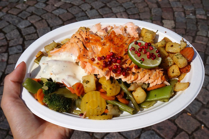 Salmon, potatoes, berries and vegetables on a crowded plate at Market Square in Helsinki, Finland Salmon, potatoes, berries and vegetables on a crowded plate at Market Square in Helsinki, Finland