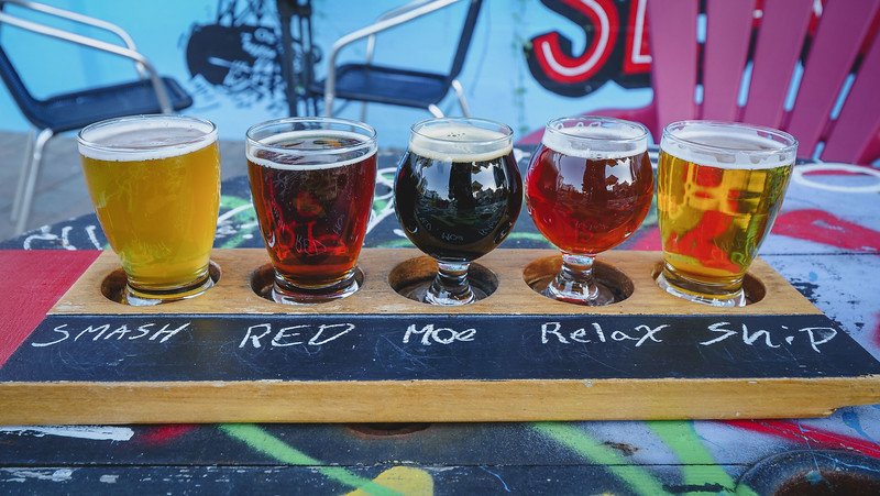Sampling craft beer at Garrison Brewing in Halifax, Nova Scotia with flavours and varieties such as smash, red, moe, relax and ship on offer 