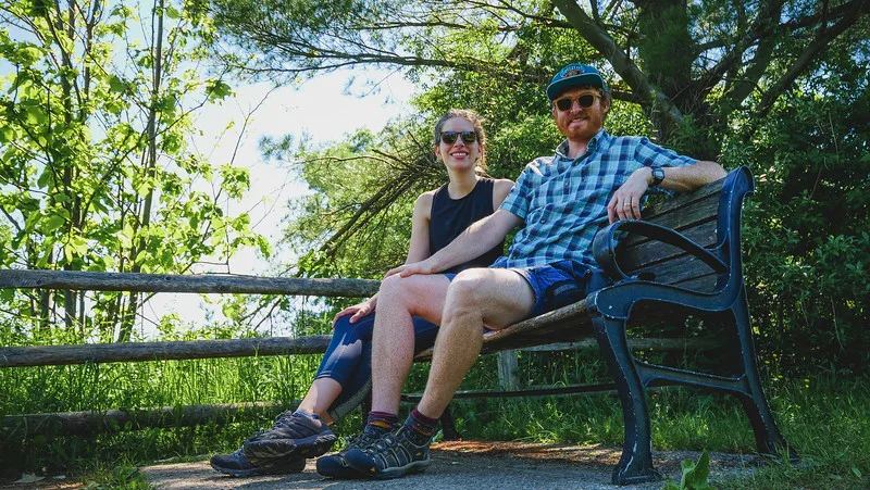 Samuel and Audrey taking a break on a park bench after hiking in Rouge National Urban Park in Toronto, Ontario Samuel and Audrey taking a break on a park bench after hiking in Rouge National Urban Park in Toronto, Ontario