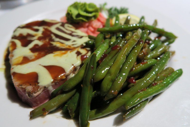 Seafood dinner at Marker 88 with green peans and a delicious sauce on top - dining experience traveling the Florida Keys 