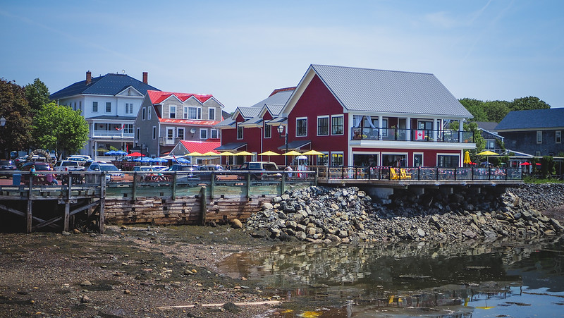 Seafood restaurants line the waterfront in St. Andrews, New Brunswick with outdoor patios and charming colorful buildings 