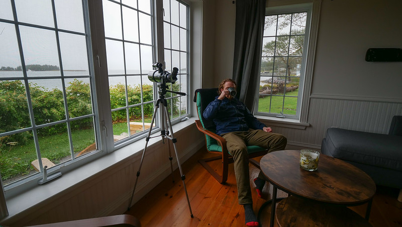 Seaside cottage in Isle Madame on Southern Cape Breton Island, Nova Scotia with Nomadic Samuel enjoying a coffee and views outside the window