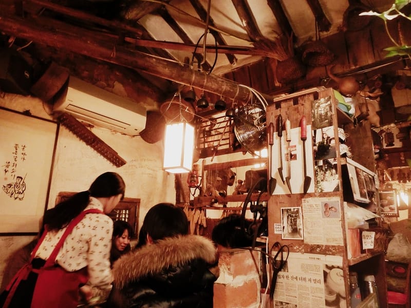Serving tea to guests of the teahouse in Insadong, Seoul, Korea with views of all the rustic details inside