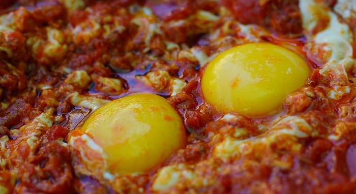 Shakshouka macro details is an Israeli dish made with tomato sauce and eggs in Israel