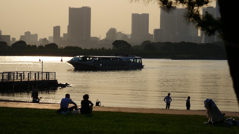 Ship transporting passengers near the beach in Odaiba, Japan Ship transporting passengers near the beach in Odaiba, Japan