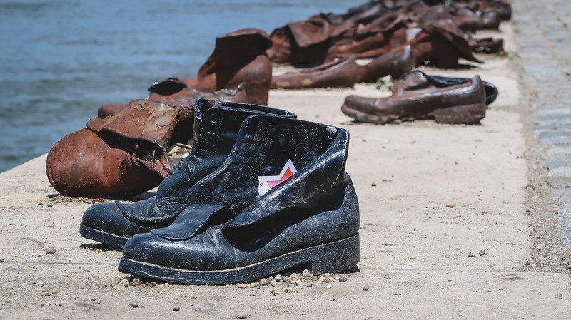 Close-up of worn shoes at the Shoes on the Danube Bank memorial in Budapest, Hungary, commemorating the victims who were shot along the river during World War II. This powerful riverside site is one of the most moving attractions to visit in Budapest