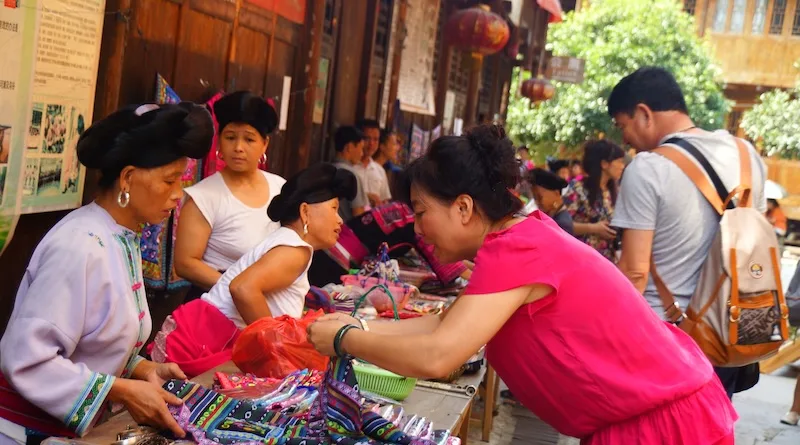 Shopping for local souvenirs at Longji yao ceremony in China 
