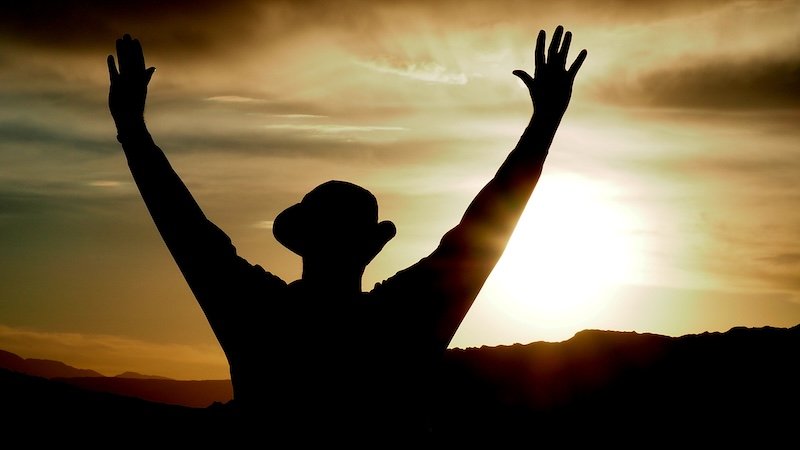 Silhouette of a man with arms raised during a dramatic sunset in Valle de la Luna, Atacama Desert, Chile Silhouette of a man with arms raised during a dramatic sunset in Valle de la Luna, Atacama Desert, Chile